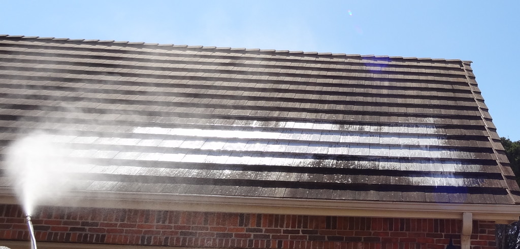 Applying environmentally safe chemicals to roof tiles.